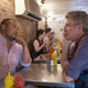 David Chang and Anthony Bourdain sitting at a restaurant table talking